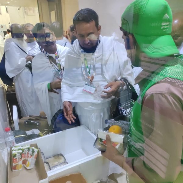 موظف يقدّم وجبة لحاج